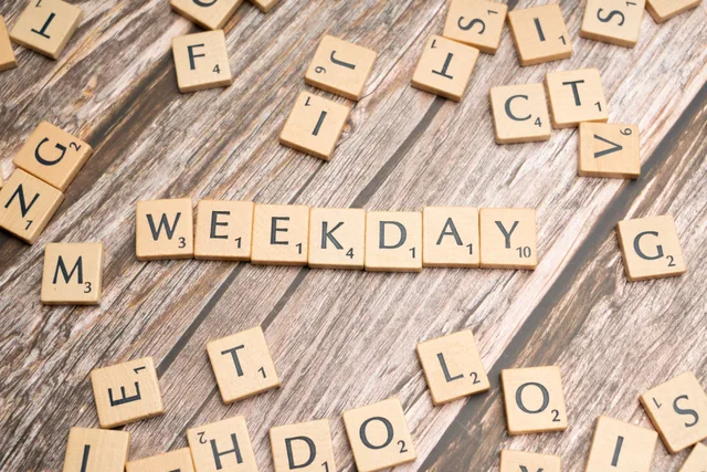 Scattered wooden letter tiles spell 'WEEKDAY' on a rustic wooden surface. A working brief on add business days formula as of 2027