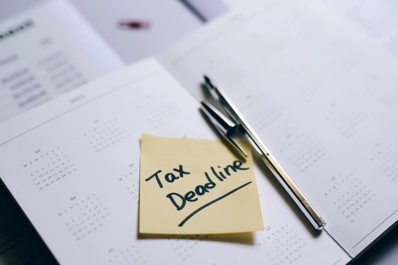 A close-up of a calendar with a sticky note reminding about the tax deadline. Best subtract business days tools 2027: facts and context, explained properly