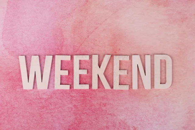 Creative display of the word 'Weekend' in wooden letters on a textured pink background. Multiple working calendars in one Excel sheet: WORKDAY.INTL weekend strings